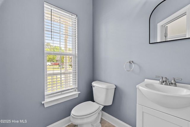 141 Trevor Way, Moyock, NC 27958 - half bath with vanity, toilet, baseboards, and plenty of natural light