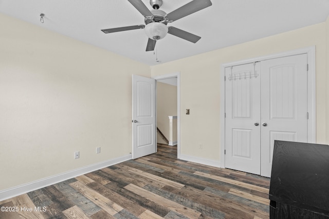 141 Trevor Way, Moyock, NC 27958 - unfurnished bedroom with baseboards, a closet, a ceiling fan, and wood finished floors