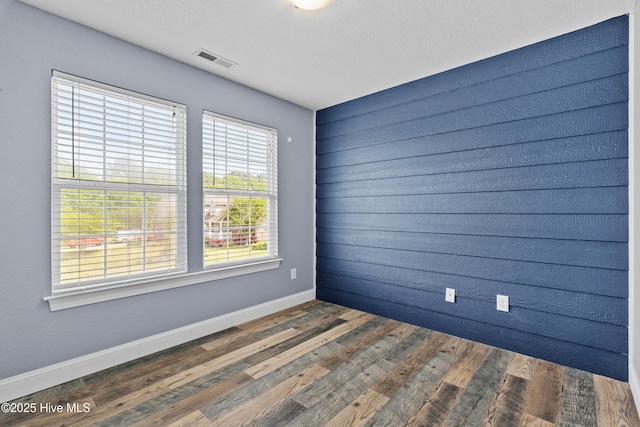 141 Trevor Way, Moyock, NC 27958 - spare room featuring baseboards, visible vents, and wood finished floors