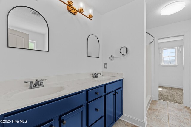 141 Trevor Way, Moyock, NC 27958 - full bathroom with a sink, double vanity, baseboards, and tile patterned floors