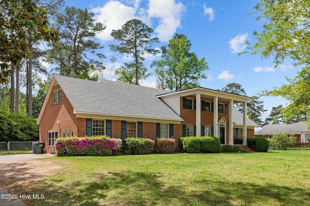 neoclassical home with brick siding and roof with shingles