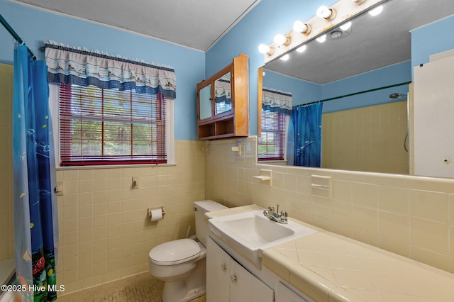 bathroom featuring toilet, curtained shower, tile walls, tile patterned floors, and vanity