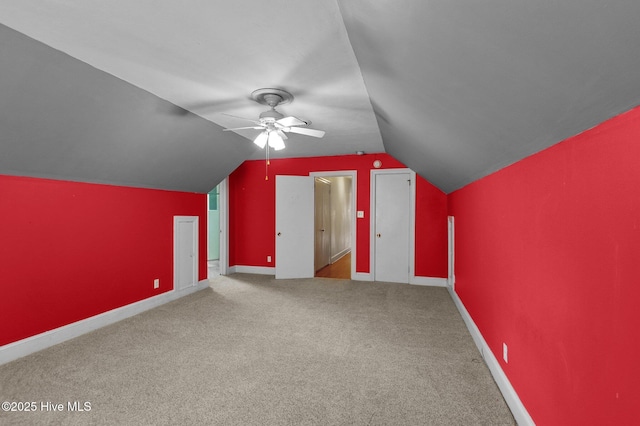 additional living space featuring carpet, ceiling fan, vaulted ceiling, and baseboards