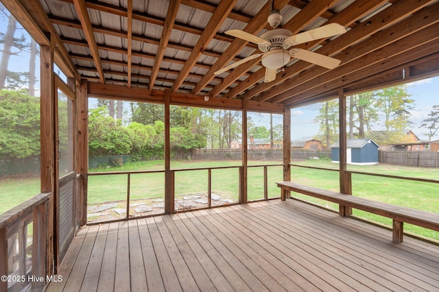 unfurnished sunroom featuring a ceiling fan