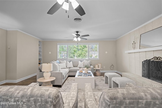502 Thomas Ave, Wilmington, NC 28405 - living room with baseboards, ornamental molding, a brick fireplace, visible vents, and ceiling fan