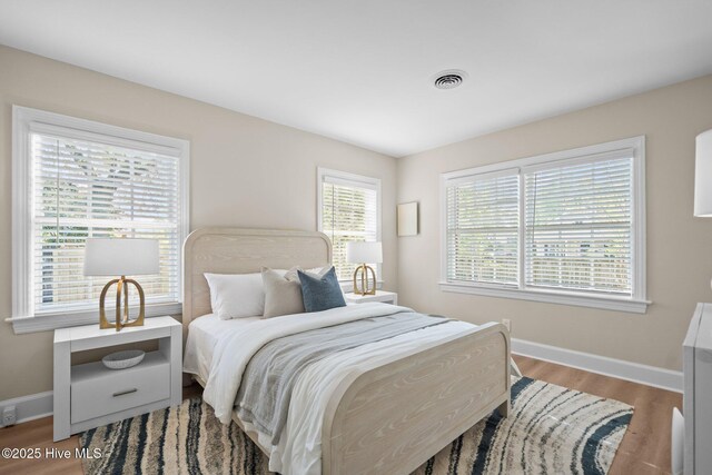 502 Thomas Ave, Wilmington, NC 28405 - bedroom with visible vents, baseboards, and wood finished floors
