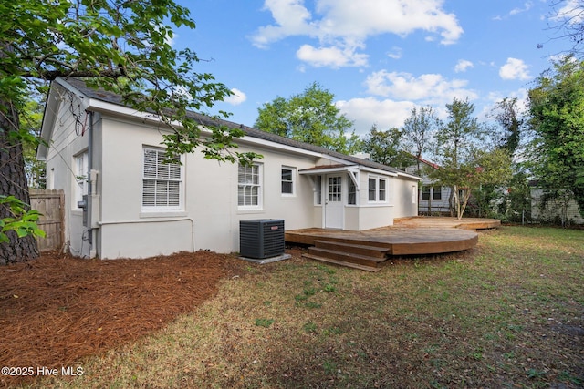 502 Thomas Ave, Wilmington, NC 28405 - back of house with central air condition unit, a lawn, fence, stucco siding, and a wooden deck