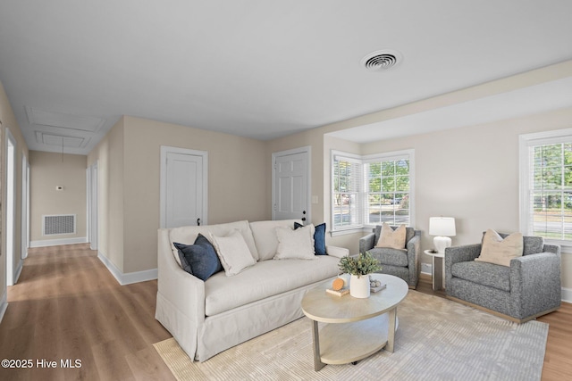 502 Thomas Ave, Wilmington, NC 28405 - living room with wood finished floors, attic access, baseboards, and visible vents
