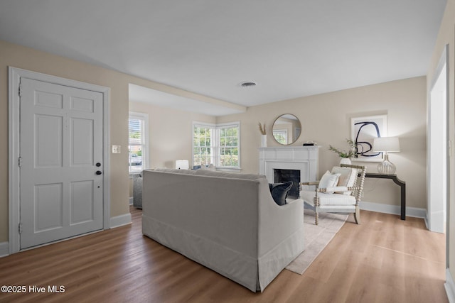 502 Thomas Ave, Wilmington, NC 28405 - living room featuring visible vents, baseboards, light wood finished floors, and a fireplace