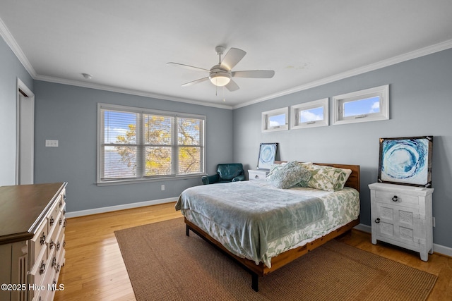 bedroom featuring a ceiling fan, baseboards, ornamental molding, and light wood finished floors