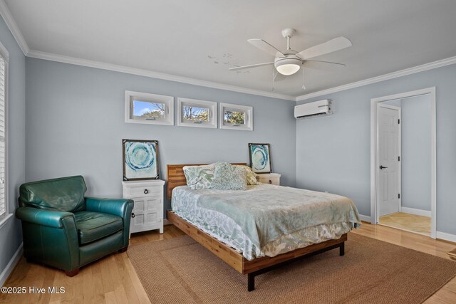 bedroom with crown molding, wood finished floors, and a wall unit AC