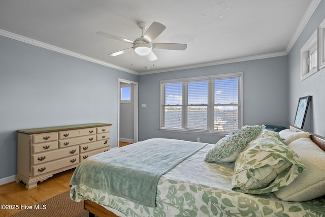 bedroom with baseboards, light wood-style floors, ceiling fan, and crown molding