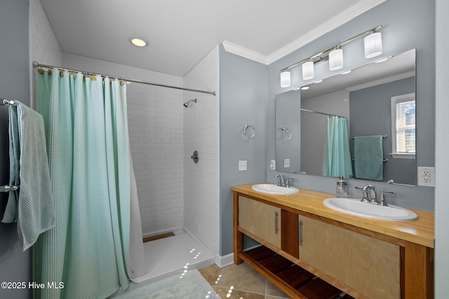 full bathroom featuring tile patterned floors, a sink, ornamental molding, and a tile shower