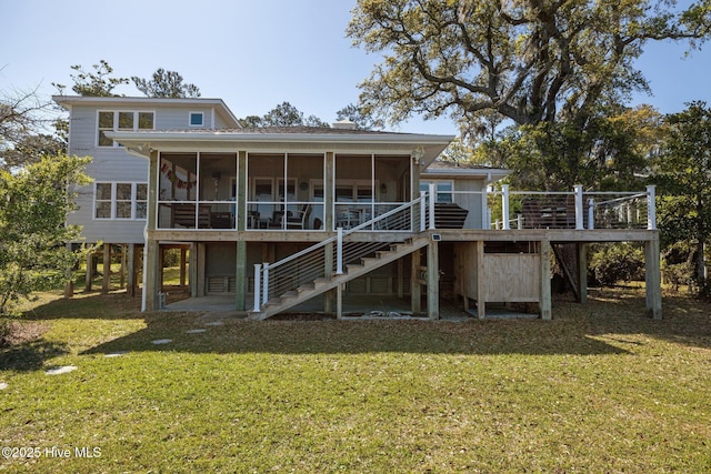 rear view of property with a wooden deck, stairway, a yard, and a sunroom