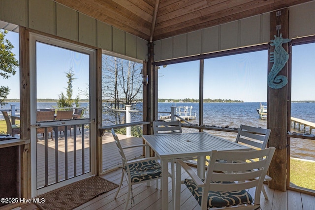 sunroom featuring a water view and a healthy amount of sunlight