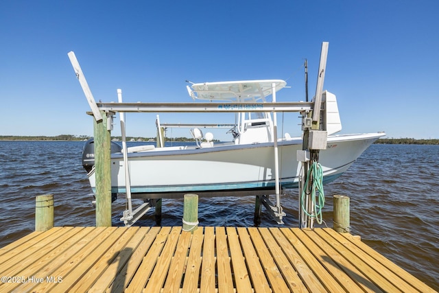 dock area with boat lift and a water view