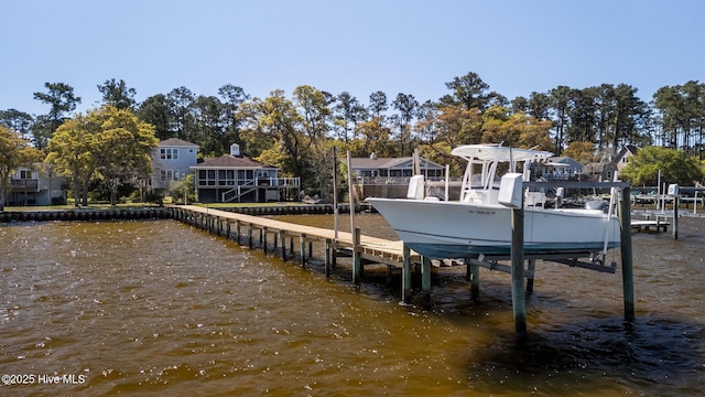 view of dock with boat lift and a water view