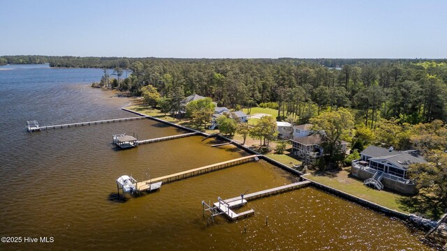 aerial view with a wooded view and a water view