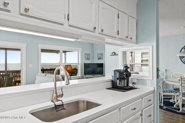 2709 W Beach Dr, Oak Island, NC 28465 - kitchen with a sink, dark wood finished floors, white cabinets, and light countertops