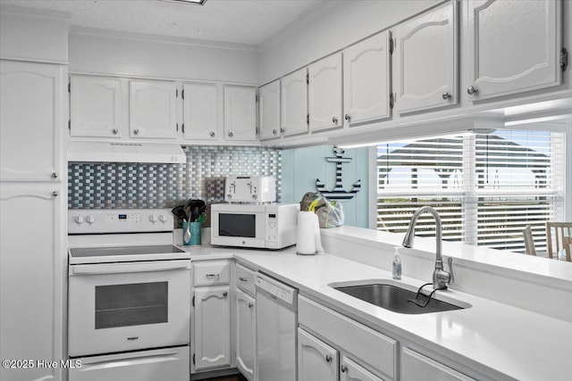 2709 W Beach Dr, Oak Island, NC 28465 - kitchen with a sink, under cabinet range hood, white cabinets, and white appliances