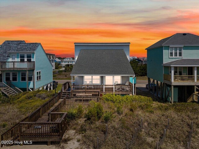 view of back of house at dusk