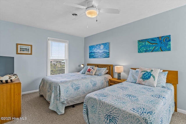 carpeted bedroom featuring baseboards, a ceiling fan, and visible vents