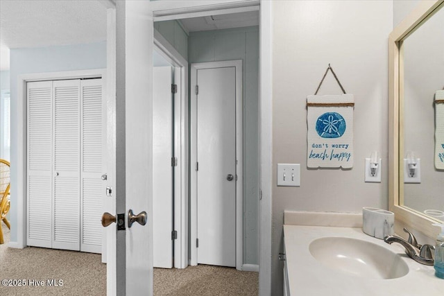 bathroom featuring a closet and vanity