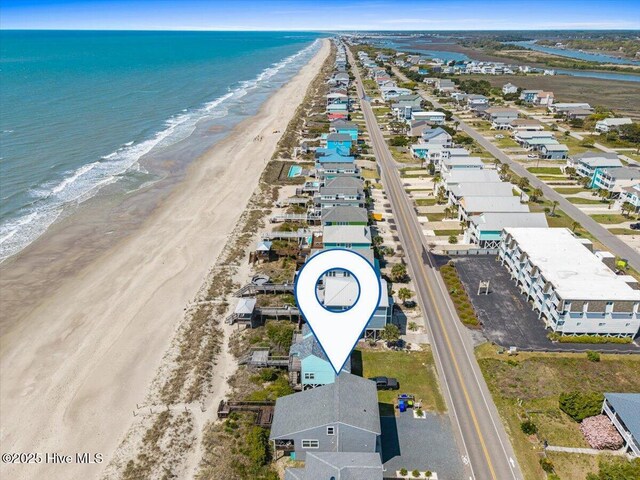 drone / aerial view with a beach view and a water view