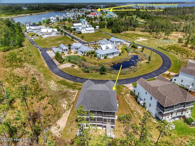 birds eye view of property featuring a residential view and a water view