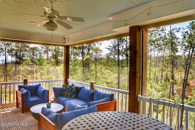 sunroom featuring an outdoor hangout area, a ceiling fan, and a wealth of natural light