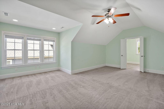 bonus room with ceiling fan, visible vents, baseboards, lofted ceiling, and carpet flooring