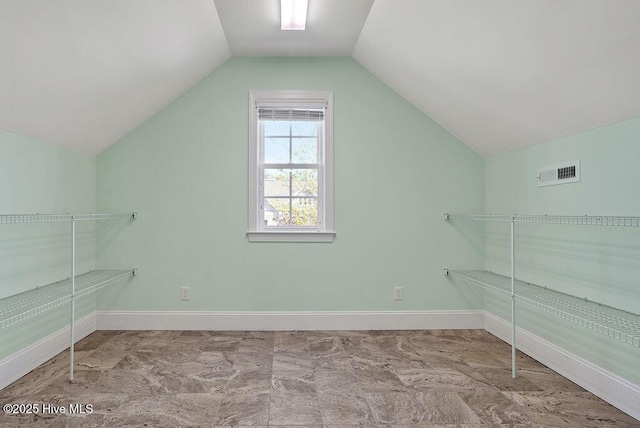 spacious closet featuring vaulted ceiling and visible vents