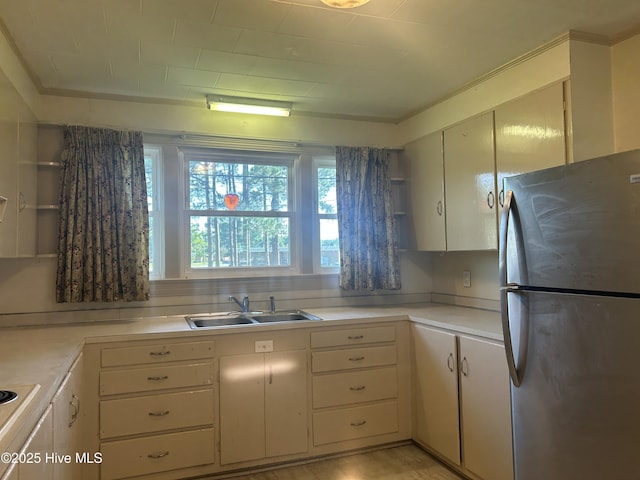 500 Rowan Rd, Clinton, NC 28328 - kitchen with freestanding refrigerator, a sink, light countertops, white cabinets, and crown molding