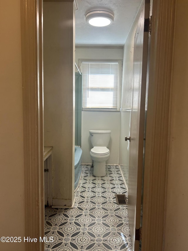 500 Rowan Rd, Clinton, NC 28328 - full bath featuring toilet, a shower, and tile patterned floors