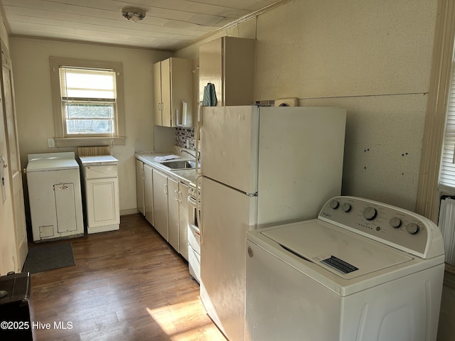 500 Rowan Rd, Clinton, NC 28328 - kitchen featuring washer / clothes dryer, a sink, light wood-type flooring, and light countertops