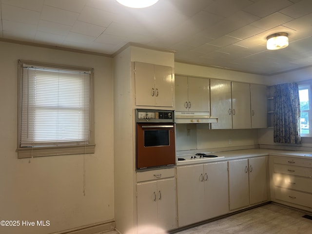 500 Rowan Rd, Clinton, NC 28328 - kitchen with wall oven, white cooktop, ornamental molding, light countertops, and under cabinet range hood