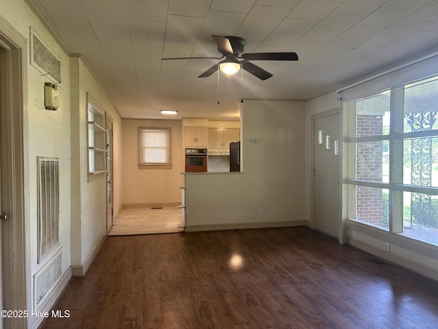 500 Rowan Rd, Clinton, NC 28328 - unfurnished living room with healthy amount of natural light, wood finished floors, and a ceiling fan