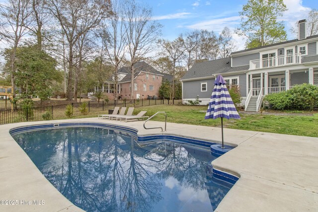 view of pool featuring fence, a fenced in pool, a yard, and a patio area