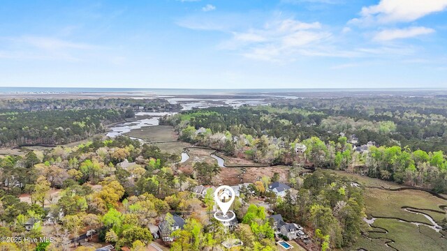 aerial view featuring a forest view and a water view