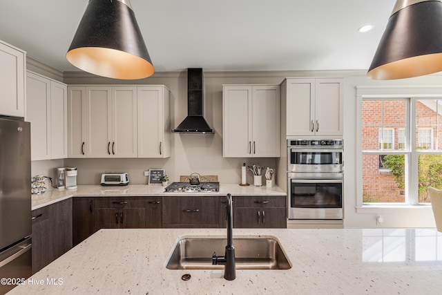 392 Blossom Tree Ln SE, Bolivia, NC 28422 - kitchen featuring wall chimney exhaust hood, stainless steel appliances, a sink, light stone counters, and recessed lighting