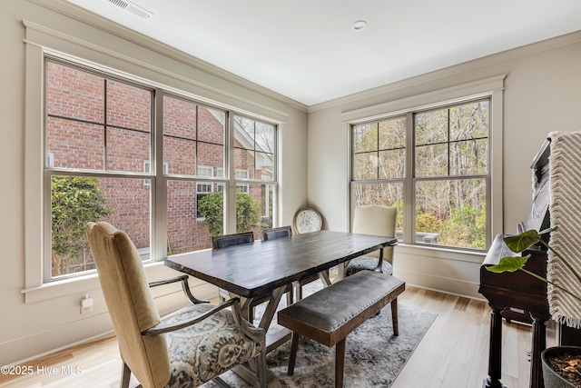 392 Blossom Tree Ln SE, Bolivia, NC 28422 - dining space featuring light wood-type flooring, baseboards, and crown molding