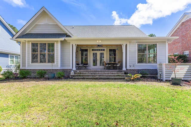 392 Blossom Tree Ln SE, Bolivia, NC 28422 - view of front of house with french doors, a porch, a front lawn, and a shingled roof