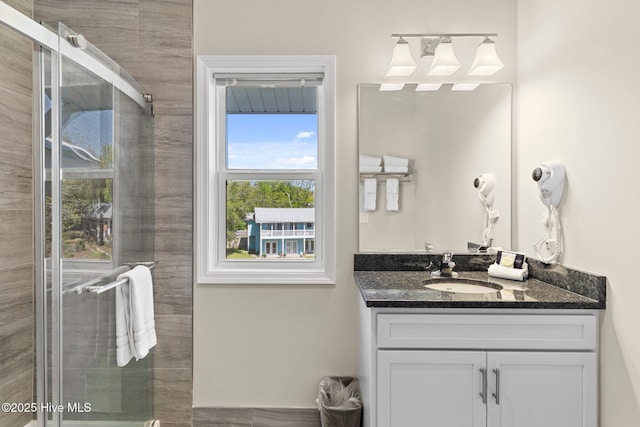 bathroom featuring a stall shower and vanity