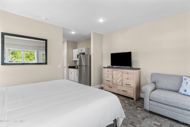 bedroom with baseboards, dark carpet, recessed lighting, and freestanding refrigerator