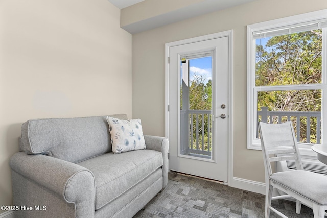 living area with baseboards and carpet floors