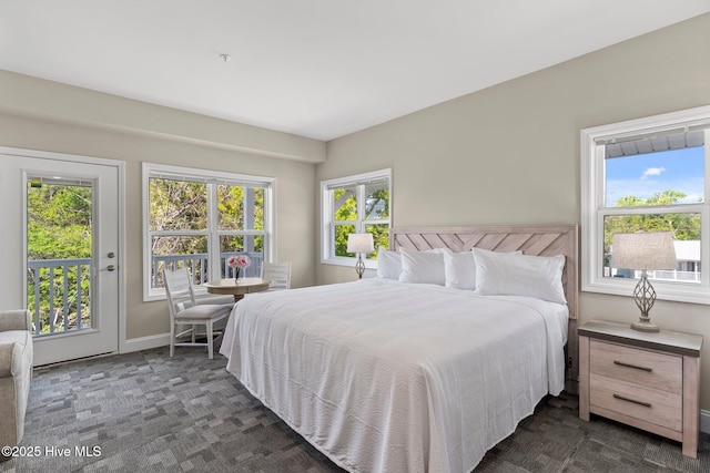 bedroom with baseboards, access to exterior, and dark carpet