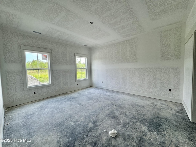 spare room with visible vents, a textured ceiling, and concrete flooring