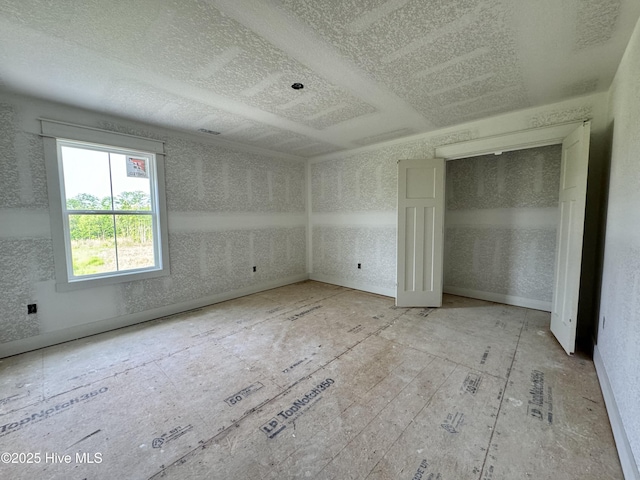 unfurnished bedroom with a textured ceiling