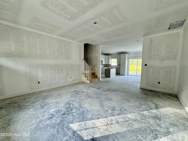 unfurnished living room featuring baseboards, concrete flooring, stairs, and a textured ceiling