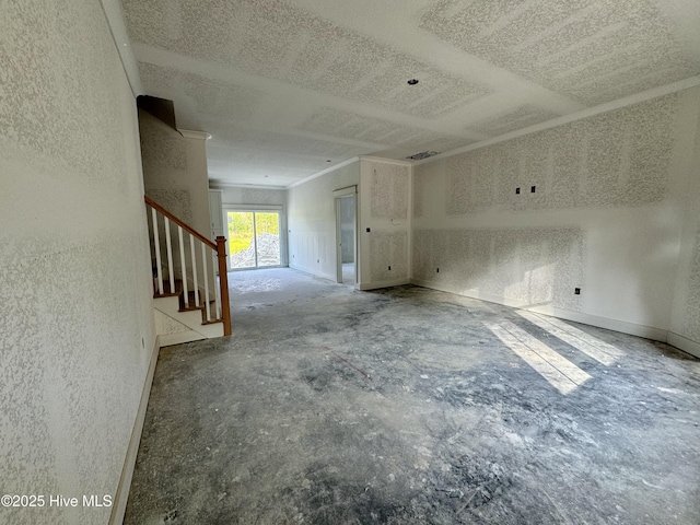 spare room with a textured wall and stairway